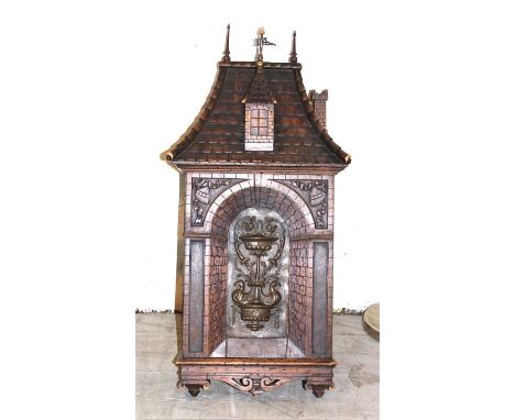 A North European carved oak tabernacle, late 19th century, having hinged door carved with stone archway enclosing brass panel