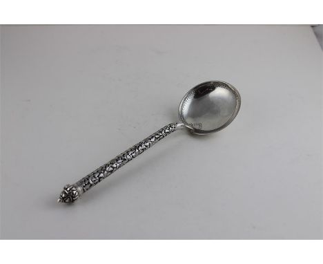 A silver ladle, probably Indian, stamped .900, having intricate scrolling vine stem and engraved border to circular bowl. Len