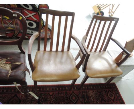 A pair of vintage teak carver chairs