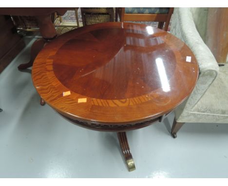 A vintage circular occasional table with veneer top