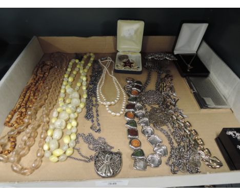 A selection of vintage costume jewellery including necklace and badges