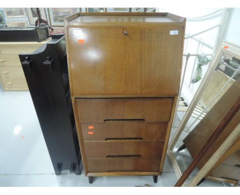 An early to mid 20th Century oak bureau having label en verso for Serlin and Sons , Tottenham, London