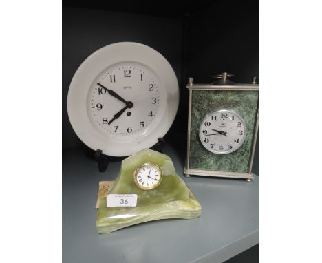 A selection of clocks including mantle and smiths wall mounted plate clock
