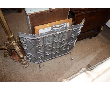 A metal and meshwork spark guard; and a coloured print of mushrooms