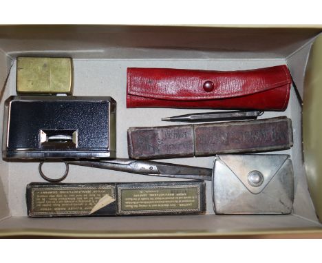 A silver propelling pencil, a pair of folding opera glasses, a Zippo lighter, cut throat razors etc.