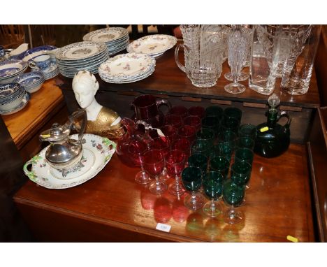 A collection of cranberry and green glass table ware to include water jug, claret jugs, various size wine glasses, an Art Dec