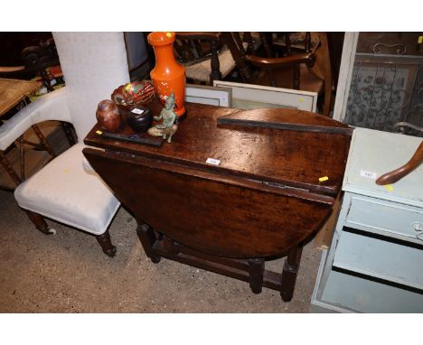 An antique oak gate leg dining table AF