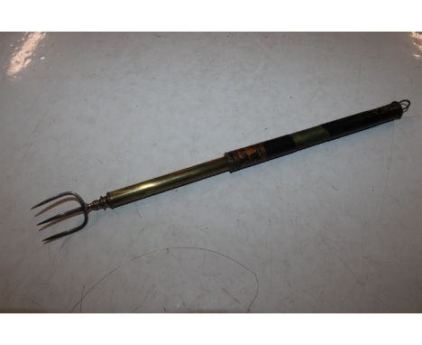 A telescopic toasting fork with silver tines 