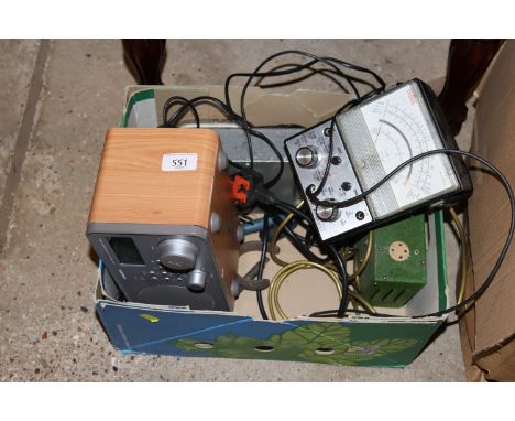 A box containing a radio, volt meters, a rustic bow and arrow etc.