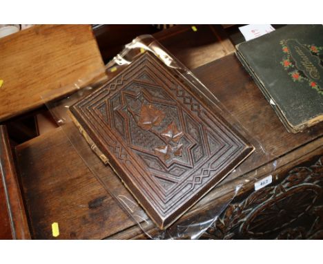 A vintage guest book with carved wooden covers 