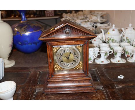 A late Victorian oak cased mantel clock with eight day movement 
