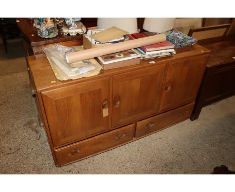 A light Ercol sideboard fitted cupboards and two drawers below 