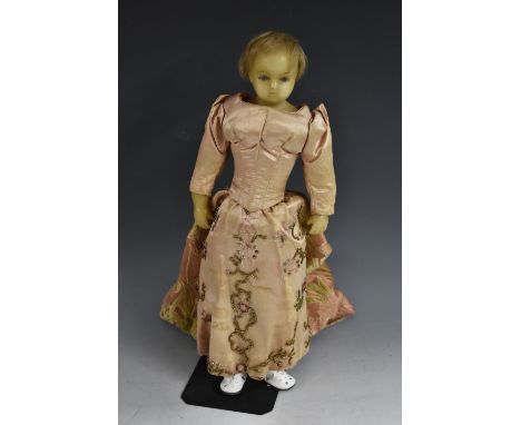 A wax head shoulder doll, cast moulded head with painted blue eyes, light brown hair, stuffed cloth body, wax arms, composite