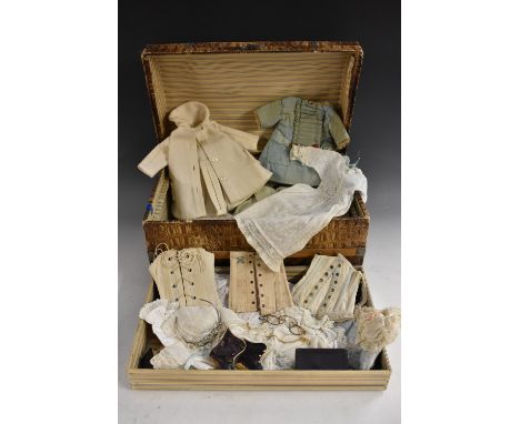 Dolls clothes - girdles, cotton underskirts, coats and dresses, in a trunk