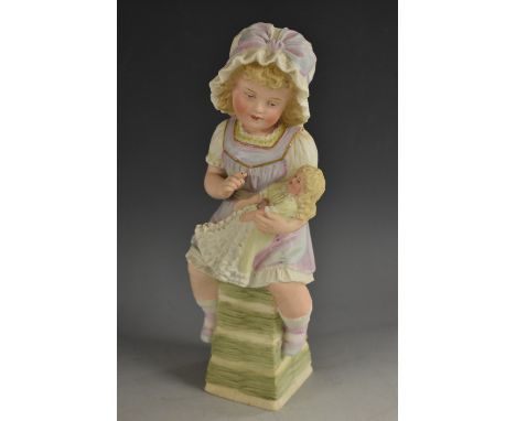 A Gebruder Heubach bisque figure, little girl seated playing with her doll, wearing a pretty dress, 28cm, c.1900