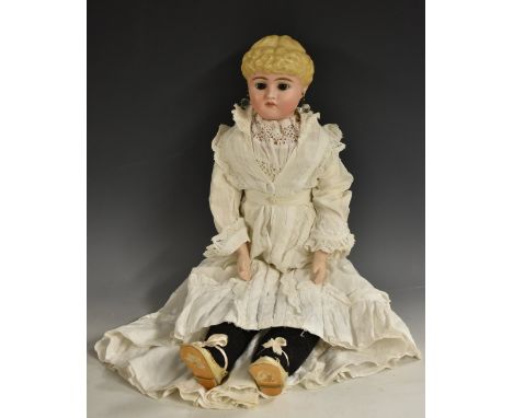 A ceramic head shoulder doll, fixed brown eyes, moulded blond hair, pierced ears, rosy complexion, stuffed leather body, cera