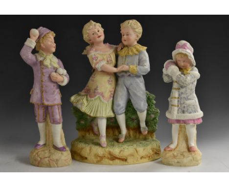 A German bisque figure, of a boy, holding snow balls, 32cm high, c.1910;  another, of a girl wearing a fur trimmed coat and m