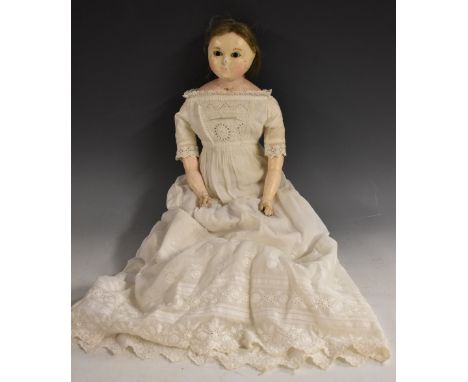 A slit head wax head shoulder doll, moulded face, inset glass eyes, light brown hair, stuffed leather body, wax lower arms an
