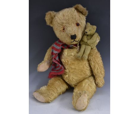 A mid 20th century doll's bear muff, button eyes, horizontal stitched  nose and mouth, 14.5cm high;  another jointed bear, 14