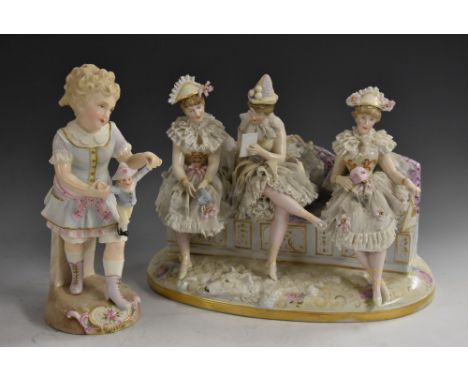 A German porcelain figure group, of three ladies, dressed in as Columbines, seated on a sofa, oval base, 28cm wide, c.1890;  