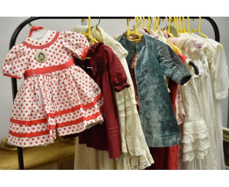 A quantity of Victorian and later dolls' clothing to include cream silk satin outfit comprising dress with pleated skirt, bea
