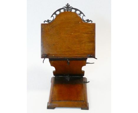 A late 19th century oak table lectern with fully articulated ratcheted folding action with arched brass crest resting on bras