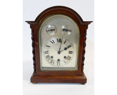 An early 20th century mahogany cased Westminster chime bracket clock with silvered dial flanked by barleytwist columns on bra