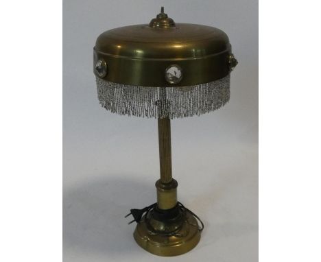 A vintage brass table lamp with glass roundels to the fringed shade on reeded column support. H.51xD.28cm 