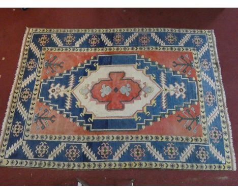 A Shirvan carpet with central lozenge medallion on burgundy field within stylised geometric triple border. 333x230cm 