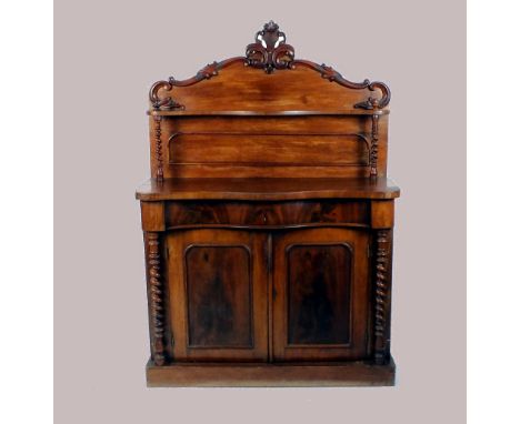 A Victorian mahogany chiffonier, the shaped panel back with foliate cresting over a serpentine shelf on barley twist columns 