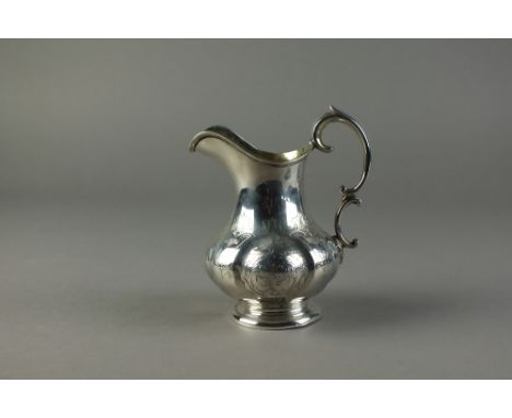 An early Victorian silver jug, Henry Wilkinson & Co, Sheffield 1854, of baluster form with engraved decoration, scroll handle