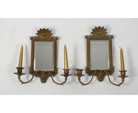 A pair of Renaissance revival wall mirrors, each with a scalloped cast gilt metal cresting and frame bevelled plate, two bran