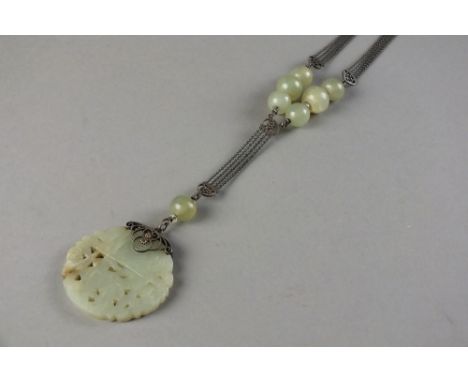 A Chinese pale green jade pendant20th CenturyOf circular form and worked with a pine branch flanked by two bats beneath a sho