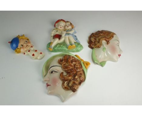 A collection of Art Deco wallmasks, including a Crown Devon Fieldings example, a Goebel example modelled as a child in the st