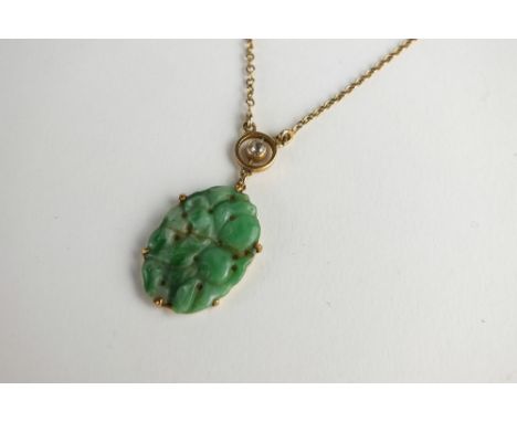 A diamond and jade pendant, designed as an oval jade plaque claw set within yellow metal and suspended from diamond set lug w