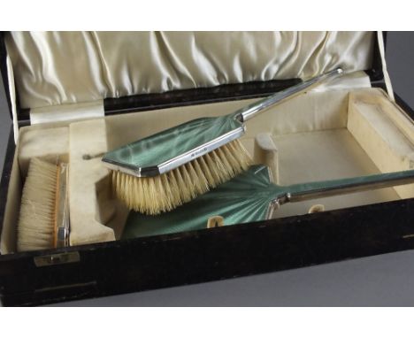 An Art Deco cased three piece silver and guilloche enamel mounted dressing table set, William Neale & Sons, Birmingham 1934, 