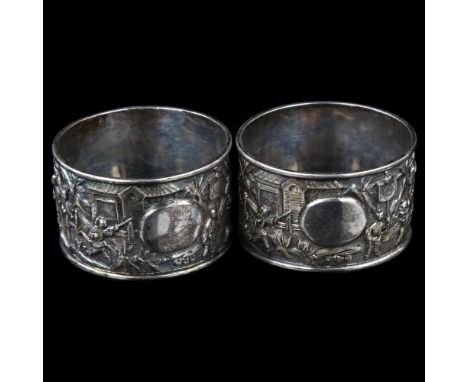 A pair of Chinese export silver napkin rings, circa 1900, relief embossed ceremonial decoration, diameter 5cm, 1.8ozNo damage