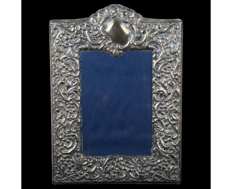 An Elizabeth II silver-fronted photo frame, relief embossed foliate decoration, by Carr's, hallmarks Sheffield 1993, overall 