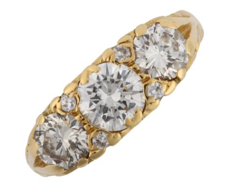 A late 20th century 18ct gold graduated three stone diamond half hoop ring, set with modern round brilliant-cut diamonds and 