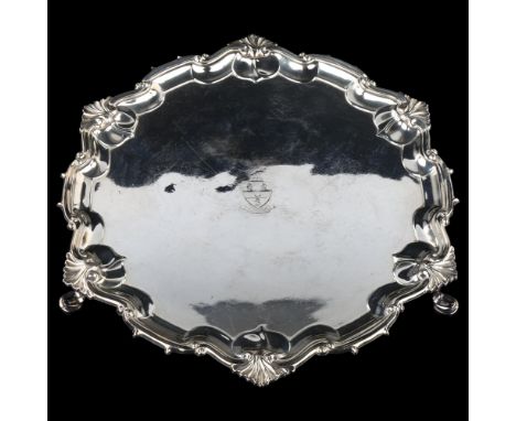 A George V silver salver, circular form with piecrust edge and foliate border, with engraved armorial crest, by William Hutto