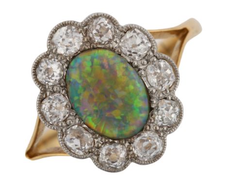 An 18ct gold black opal and diamond cluster ring, set with oval cabochon black opal and old European-cut diamonds, total diam