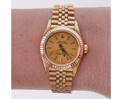 Rolex, a ladies 18ct yellow gold Oyster Perpetual chronometer wristwatch, on Jubilee concealed snap bracelet, champagne baton