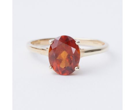 A 9ct yellow gold ring set with an oval cut 3.05ct Kurundu garnet (orange), 2.33gm, size R, comes with a Certificate of Authe