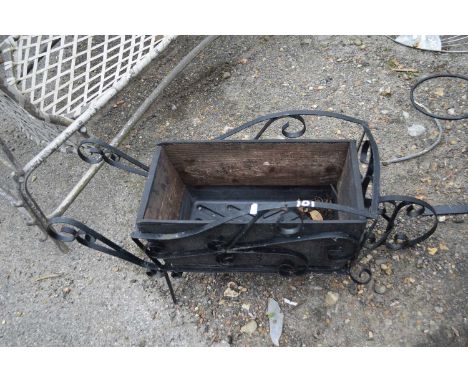 Metal planter in the shape of a wheelbarrow