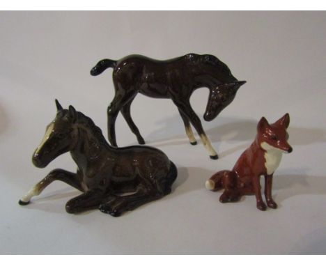 A Beswick Foal (large, head down) in brown gloss, model no. 947, Beswick Foal (lying) in brown gloss, model no. 915 and a Bes