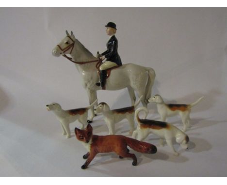 A Beswick Huntswoman on grey gloss horse, model no. 1730, Beswick Fox, model no. 1440 and four Beswick Foxhounds, model no's 