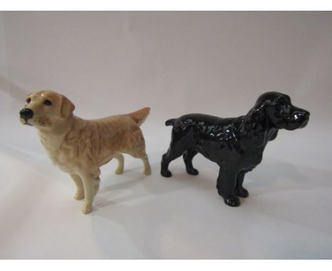 A Beswick Cocker Spaniel "Horseshoe Primula" in black gloss, model no. 967 together with a Beswick Retriever in light brown g