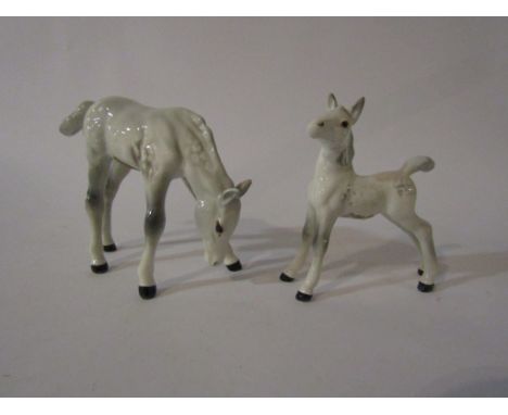 A Beswick Foal grazing in grey gloss, model no. 946, together with a Beswick Foal stretched in grey gloss, model no. 763 