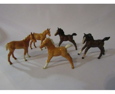 Five Beswick Foals - small gamboling, in brown gloss, model no. 996, two small stretched in brown gloss and palomino gloss, m