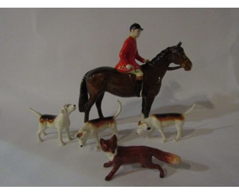 A Beswick Huntsman on brown horse, model no. 1501, Beswick Fox, model no. 1440 and three Beswick Foxhounds, model no's 2262, 